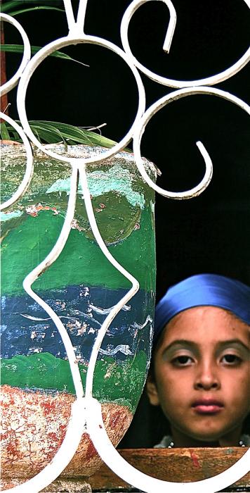 Girl In Wrought Iron Window, León. Photograph by Dan Mangan